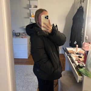 Dunjacka - Svart oversized dunjacka från Monki i strl XS. Perfekt till vintern då den är väldigt varm + har fodrade innerfickor. Enda defekten är att vi sytt på knappen till ena innerfickan då den ramlade av, annars som ny🩷