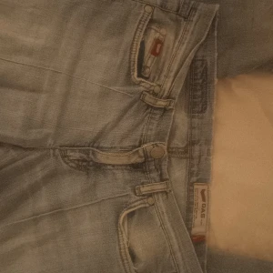 Ljusa, lågmidjade jeans från Gas - Säljer ett par ljusa jeans från Gas med SLITNA DETALJER och klassisk femficksdesign. Jeansen har en rak/flared passform och är perfekta för en lite avslappnad stil. De har en knappgylf och bälteshällor. Storleken är W28L34 men passar mig som brukar vara W24. Kan sänka priset.