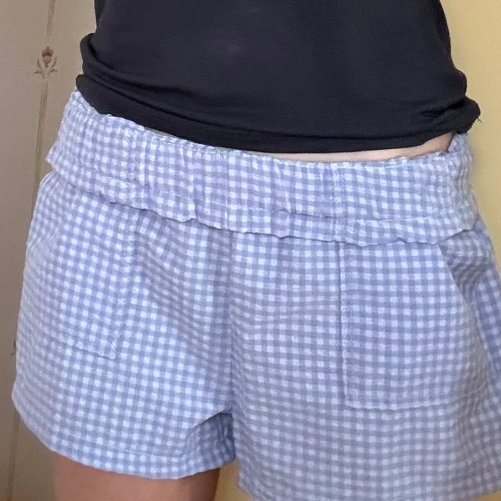 Säljer ett par blå/lila-rutiga shorts från H&M. 💕💕De har en bekväm elastisk midja med knytband och två praktiska fickor framtill. Perfekta för en avslappnad stil. Säljer då de är för små för mig nu. Skriv innan köp gärna!🥰. Shortsit.