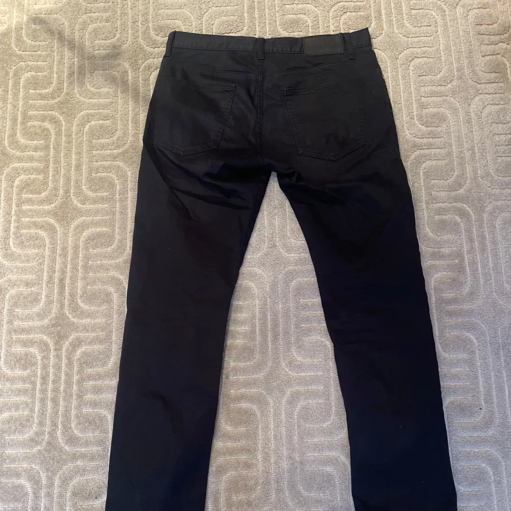 Svarta golf byxor från J.Lindberg, slim fit W30 L32. Farkut & Housut.