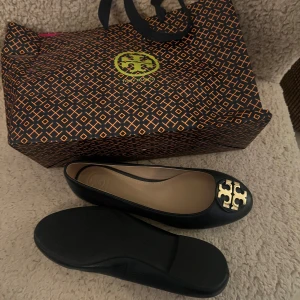 Mörkblåa ballerinaskor Tory Burch  - Eleganta mörkblåa ballerinaskor med en iögonfallande gulddetalj på tån. Aldrig använda, för småa för mig😇 Toppenskor! 