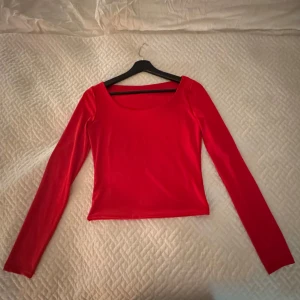 Silke topp röd - Säljer en röd topp i silkeskänsla. Fått av min mor och finns ingen tag än den som är med på bild.  Aldrig använd/tvättad.  Storlek s/m skulle jag säga då den både sitter väldigt fint på mig och min mor. 