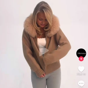 Beige stickad jacka med pälshuva - Säljer en snygg beige stickad jacka med en fluffig pälshuva. Jackan har dragkedja framtill och ribbade muddar vid ärmslut och nederkant. Perfekt för kyliga dagar! Använd en gång 