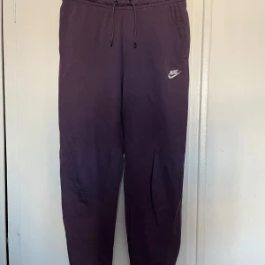 Lila mjukisbyxor från Nike - Säljer ett par lila mjukisbyxor från Stadium. Funkar både som träningsbyxor och till vardag. Super sköna!! 🤩🤩