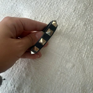 Valentino armband - Säljer mitt armband från Valentino, inköpt 2019 men sparsamt använt och ser inte slitet ut om man inte kollar noga. Originalkartong, dustbag samt två extra nitar medföljer, nypris 3000. Skicka gärna meddelande om det är något du undrar över✨🖤