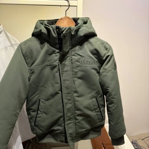 Mörkgrön jacka från Hilfiger, junior - Snygg mörkgrön jacka från Hilfiger. Använd ett fåtal gånger.