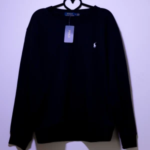 Polo Ralph Lauren Sweatshirt - Snygg svart tröja från Polo Ralph Lauren med det klassiska logotypbroderiet på bröstet. Tröjan har långa ärmar och en rund halsringning. Perfekt för en stilren look.