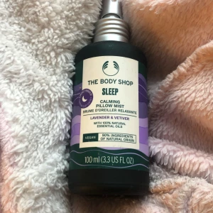 Calming Pillow Mist från The Body Shop - Säljer en Calming Pillow Mist från The Body Shop med doft av lavendel och vetiver. Flaskan är 100 ml och innehåller 100% naturliga eteriska oljor. Perfekt för en lugnande atmosfär vid sänggåendet. Flaskan är gjord av återvunnet glas och är helt återvinningsbar.