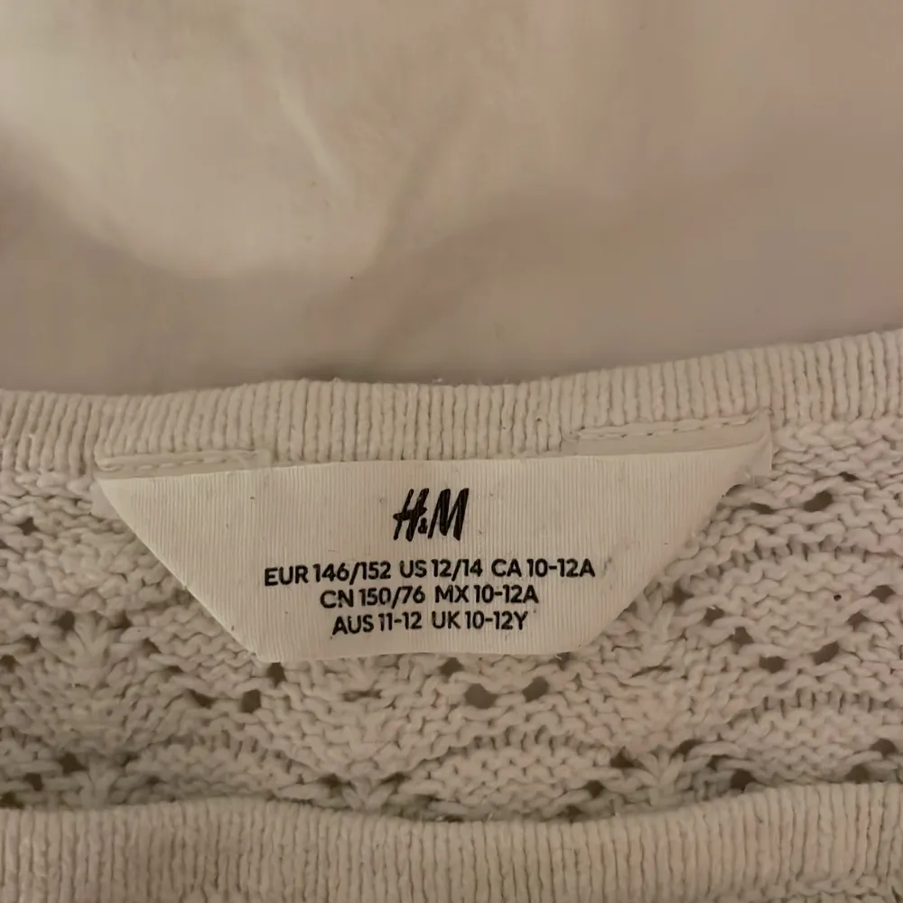 Säljer en söt vit stickad topp från H&M i storlek 146/152. Den är använd fåtal gånger. Det är en ganska kort magtröja. Och den passar perfekt på sommar med ett par linne byxor . Toppar.