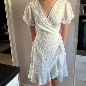 Vit omlottklänning - Superfin vit omlottklänning från SHEIN i storlek L, sitter däremot som en S. Är bara lite genomskinlig i övre ryggen där bak men inte på övriga ställen. Aldrig använd💞