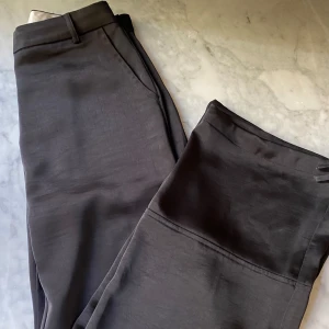 Svarta satinbyxor - Svarta satinbyxor från Neo Noir i storlek 34. Passar mig som 36.