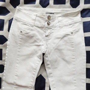 Vita skinny jeans - Säljer ett par snygga vita skinny jeans. De är högmidjade med två knappar och dragkedja fram. 