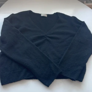 Svart stickad tröja från JDY - Mysig svart stickad tröja från JDY med v-ringning. Perfekt för kyliga dagar och passar både till vardags och lite finare tillfällen. Tröjan har långa ärmar och en bekväm passform. Ett måste i garderoben för höst och vinter! Ogrenad pris 200kr