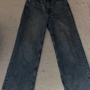 Blå jeansbyxor från H&M - Säljer ett par snygga blå jeansbyxor från H&M i storlek S/38. Baggy fit high waisted.