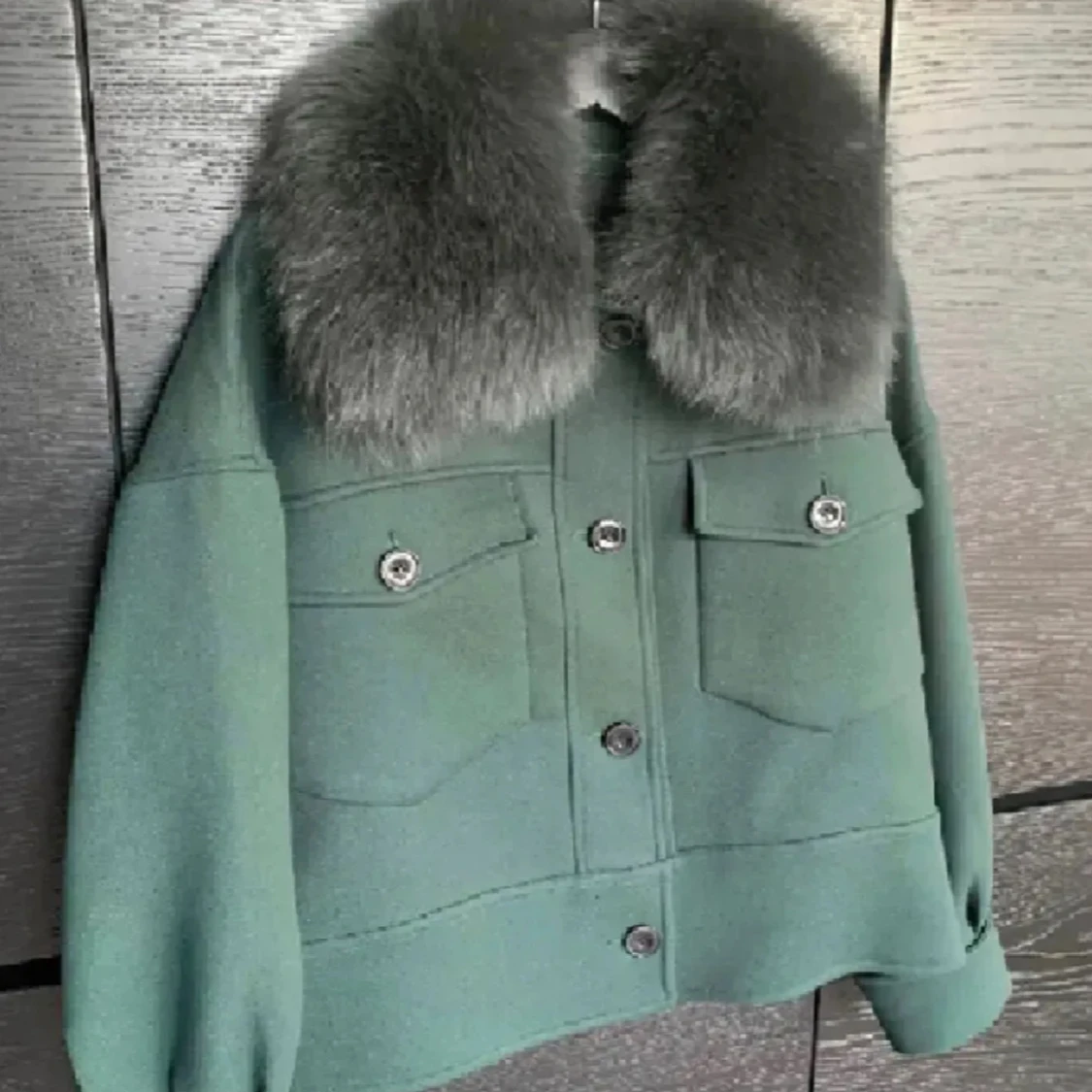 Grön jacka med pälsdetalj