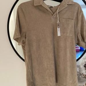 En frotté tröja - En frotté t-shirt med storleken m köpt på brothers med lappen kvar har växt ur den