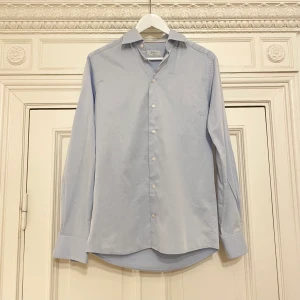 ETON skjorta ljusblå, storlek 38 - Eton skjorta storlek 38 i bra begagnat skick. Tecken på användning finns. Jag har flera olika varianter till salu. Nypris: 2000 kr. Köpet är slutgiltigt.