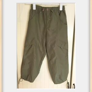  cargopants med snörning - Snygga tunna cargopants med elastisk midja och praktiska fickor på sidorna. Byxorna har justerbar snörning vid bensluten för en anpassad passform. Perfekta för en avslappnad stil.Mycket fint skick 🌟