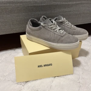 Axel arigato  - Tja. Säljer mina axel arigato skor för dom inte används mer. skick på skorn är 8/10 har använts fåtal gånger. Det finns inga skador på skorna. Box tillkommer pris kan diskuteras. Bara seriösa budare!!