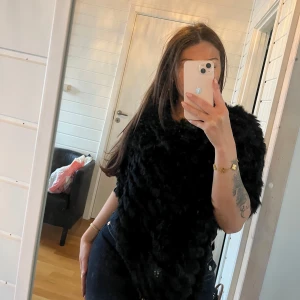 Svart pälsponcho - Säljer en supermjuk och fluffig svart poncho i kaninpäls från GB. Strl s