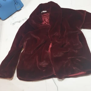 Mysig vinter jacka - Mysig vinter jacka i vinröd färg jag tror ena knappen gått sönder men jag brukar alltid ha den med ett bälte ändå! Superfin. Ganska lång när man låter den hänga men man kan puffa upp den om man har ett bälte 