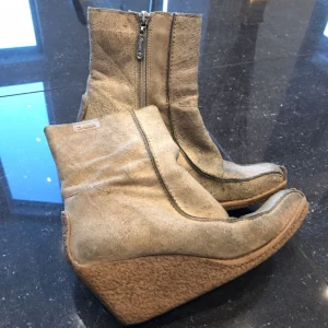  - Beiga kilklacksskor storlek 37 i mocka material. Riktigt fina skor som kan användas till vardags som till fest. Håller värmen bra nu i höst/vinter. Kan skickas mot portokostnad. 