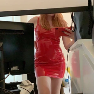 Vinyl klänning röd  - En röd klänning i glansigt och stretchigt material. Oanvänd, endast testad av min kompis (hon på bilden) skulle säga att den passar 36-38