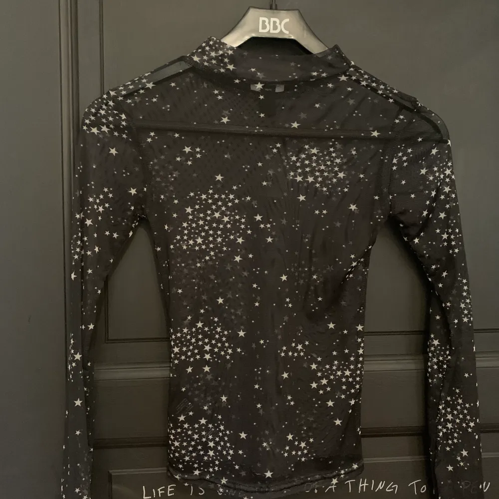 En see through/nätad tröja från asos, de vita detaljerna är små stjärnor. Säljes pga för liten, aldrig använd!. Blusar.