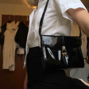  - Svart lackväska med gulddetaljer, Köpt second hand. Skriv för fler bilder 