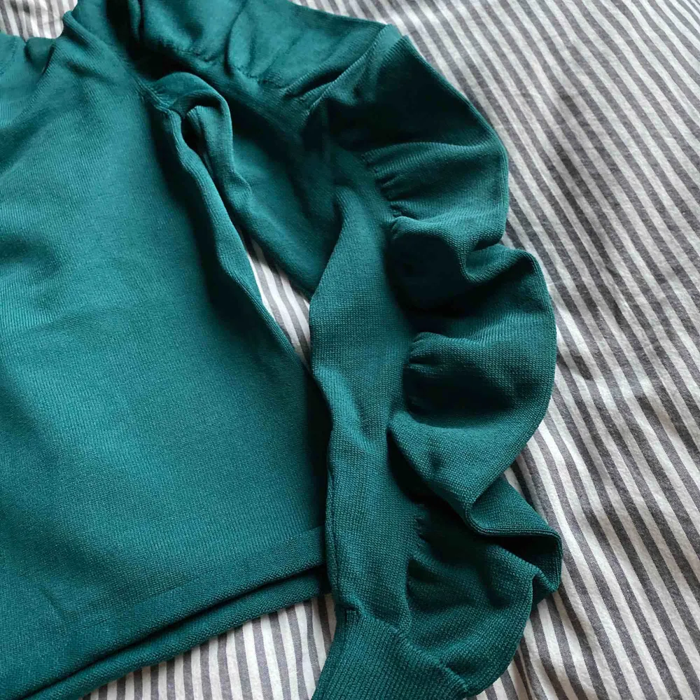 Assnygg mörkgrön tröja med puffärmar, som volanger, på ärmarna. Sitter jättesnyggt, är köpt på åhlens förra året. Frakt 49kr eller möter upp i falun💗. Toppar.