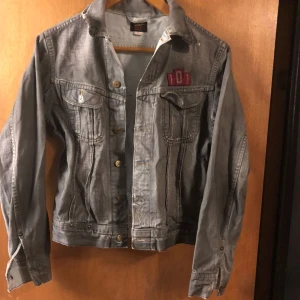  - Stentvättade svart jeansjacka . Den ”slutna”looken  Äkta LEE jacka med just LEE tryck på ryggen