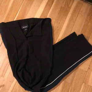  - Svarta byxor från Monki med en blå och vit rand på sidorna. Något vida nertill, skönt material. Använda kanske 3 gånger.