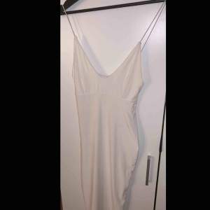 Vit klänning från Rebecca Stella i storlek S, figursydd. Köparen står för eventuell fraktkostnad. 
