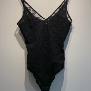 Svart body, spets - Svart body, spets, storlek xs/s. Bortklippt lapp. 60kr + frakt.