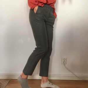 Gråa kostymbyxor - Sköna grå kostymbyxor i storlek M från Zara i stretchigt material. Resår på bakdelen av byxorna vilket ger dem en bra passform. Ena byxfollen har gått upp men den kan jag sy fast innan leverans om så önskas. Jag är 172 cm lång och använder oftast storlek 36/S.