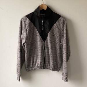 Zara tracksuit jacket. Check pattern jersey & black polyamide, zipped in the front. Size M. excellent condition, never worn.