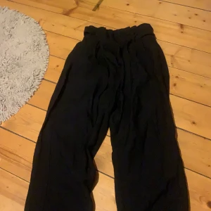 konstymbyxor - svart konstymbyxor med snöre och dragkedja. Strl 34 ifrån H&M