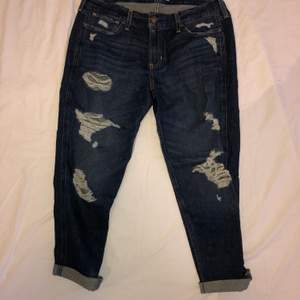 Mörkblåa boyfriend jeans med slitningar från hollister. Står att storleken är W30, men de är rätt korta i modellen. Köparen står för frakten :)