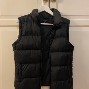 Svart dunväst - ❄️❄️ Säljer min svarta dunväst i storlek M, skulle dock säga att den är rätt liten i storleken och passar bättre en S! Lägsta pris är 150kr, köpt är köpt!