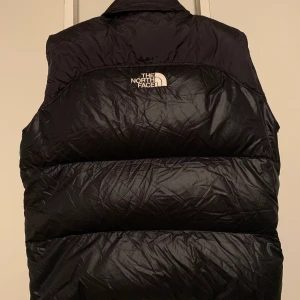 RARE KENDALL väst baby!  - Säljer nu min 1996 Nuptse väst i herr storlek Large. Sällsynt Nuptse med broderiet mitt på ryggen. Just like Kendall. Be like Kendall. Topp använt skick. En tråd sticker ur sömmen vid armhålan, se sista bild.  Skickas via PostNord Skicka Lätt. 65kr fraktkostnad tillkommer. Price is firm/fair. Swish