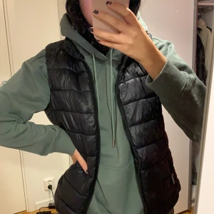 Svart dunväst - Snygg dunväst i svart, använts en del men jättebra skick. Har även en avtagbar luva. Frakt tillkommer💞