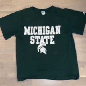 Russel Athletic  - Säljer min skitballa favorit t-shirt köpt på beyond retro, väl använd men i fint skick. Färgen är svår att se men den är ungefär pine green, skulle säga att den sitter som en L. Frakt tillkommer 