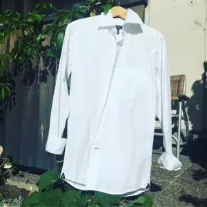 A über chique white shirt for when you want to look stylishly business! It is a bit longer and narrower, a killer together with black skinny jeans and high heels! From the high end brand Gant, with a lot of nice brand details. Practically never worn, it looks and feels brand new!