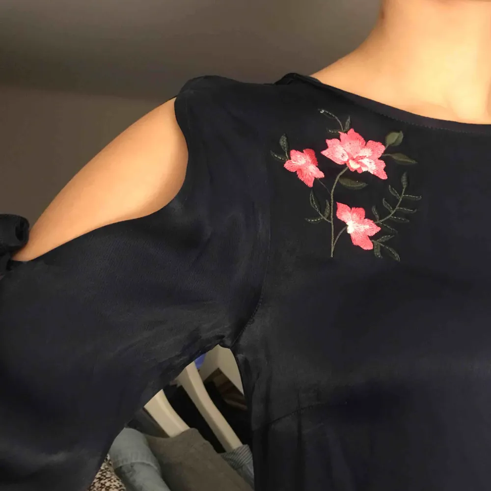 Marinblå klänning med broderade blommor vid högra bröstkorgen. Från NaKd x Andrea Hedenstedt nypris runt 500kr, kommer ej ihåg. Använd enstaka gånger. Säljer för 100kr + ev frakt.. Klänningar.