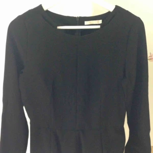  - Topp från Wera, storlek 36. Fint skräddad med markerad midja. Detalj vid halsringningen, blixtlås bak.  Jättefint skick. Ord. pris 399kr.