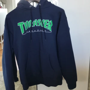 Hoodie, Thrasher - Mörkblå Hoodie med grön logga. Storlek S men stor i storleken, så passar även M