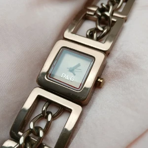  - Genuine Dolce & Gabbana wrist watch. Has been used but in a very good shape. My wrists are quite skinny (approx 16,5-17cm) and the watch sits quite snug. Camera can't quite capture the color which is dark rose gold. 