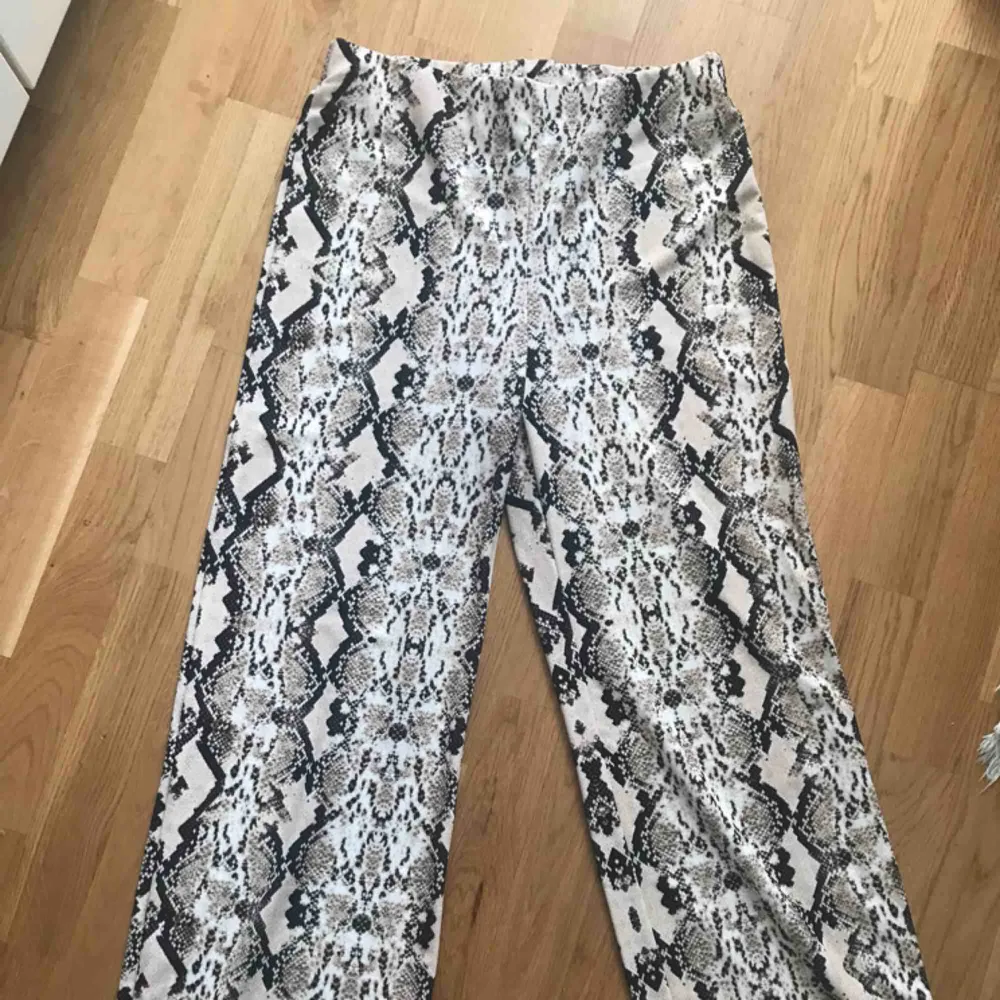 Orm/snake mönstrade byxor ifrån Gina tricot. Modellen är som de randiga byxorna på bilden. Använda 2ggr. 100% polyester . Jeans & Byxor.