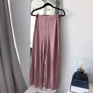  - Rosa culottes i plisserat material. Något nötta på rumpan men ingenting som syns om man inte kollar väldigt noga. (Och typ underifrån). Frakt ingår!