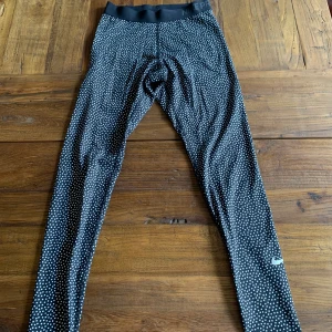 Tränings byxor från Nike - Supersköna Nike tajts i prickigt mönster, använd någon gång och är i bra skick